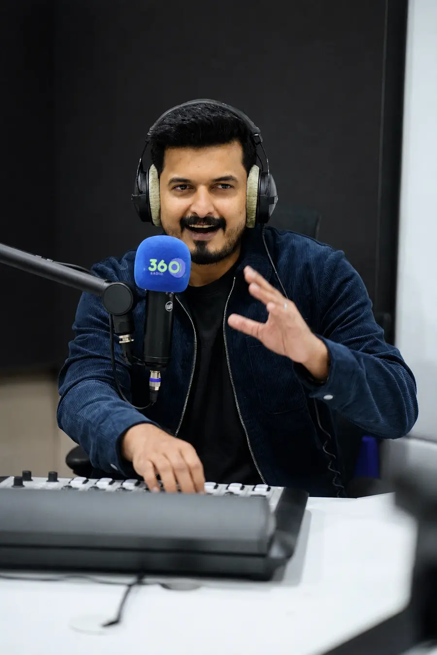 RJ Thanveer speaking during a live studio session at 360 Radio UAE